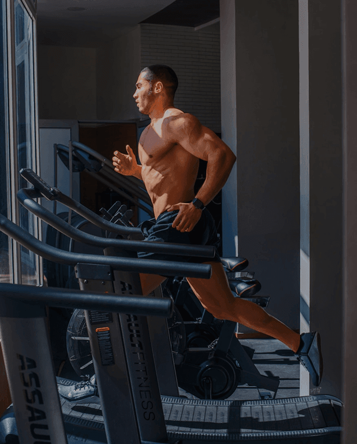 Athlete running on a treadmill in a gym