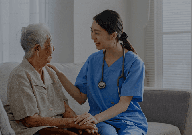 Healthcare professional caring for an elderly patient at home